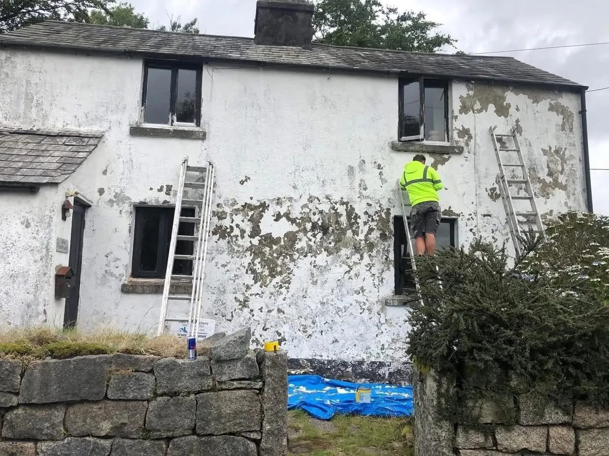 Cottage with blown, flaking render before repair in Callington